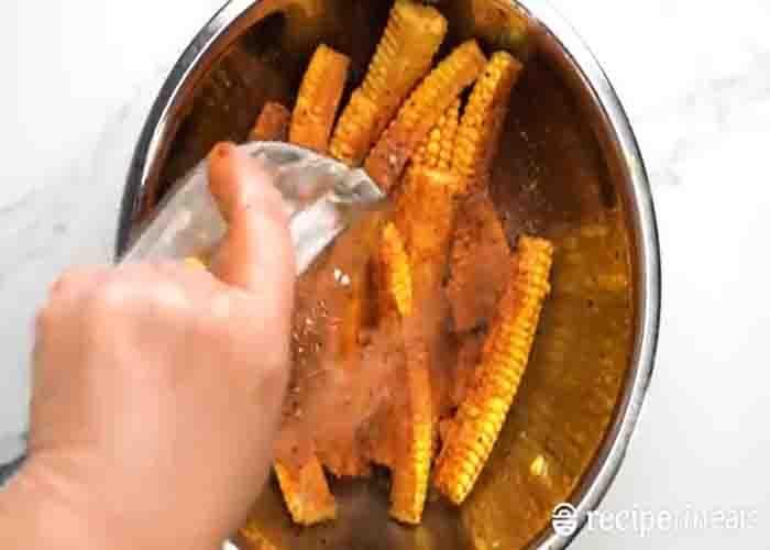 Seasoning the corn ribs