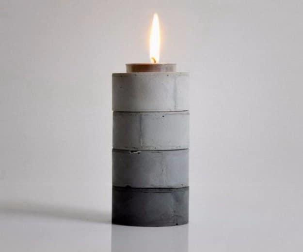DIY gradient candle holders, a stacked column of four cast cement rings shading from pale gray to charcoal with a tealight