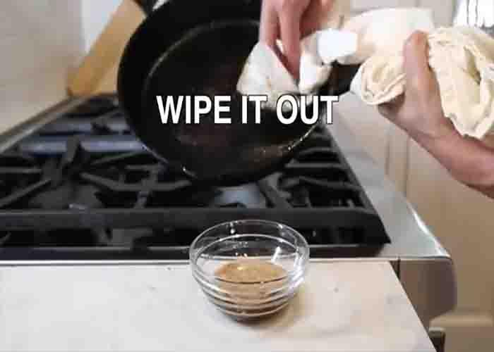 Wiping down your cast iron pan after using it