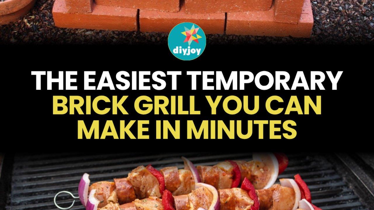 Rectangular grill built from stacked clay bricks with skewers of meat and peppers cooking over coals on a grate