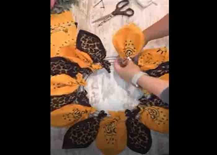 Attaching the bandanas to the wire wreath to make the sunflower