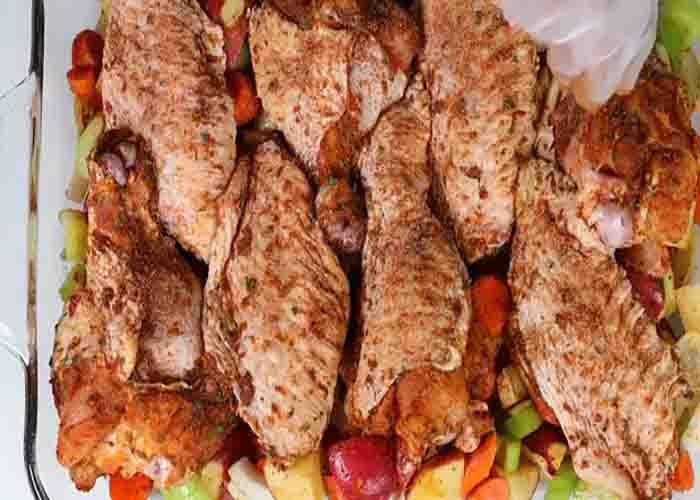 Assembling the veggies and turkey wings in the casserole dish