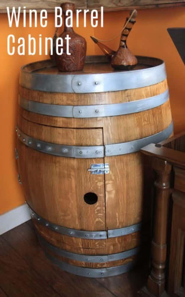 Wine barrel cabinet standing upright with a door cut into the curved oak side and two carved duck decoys on top