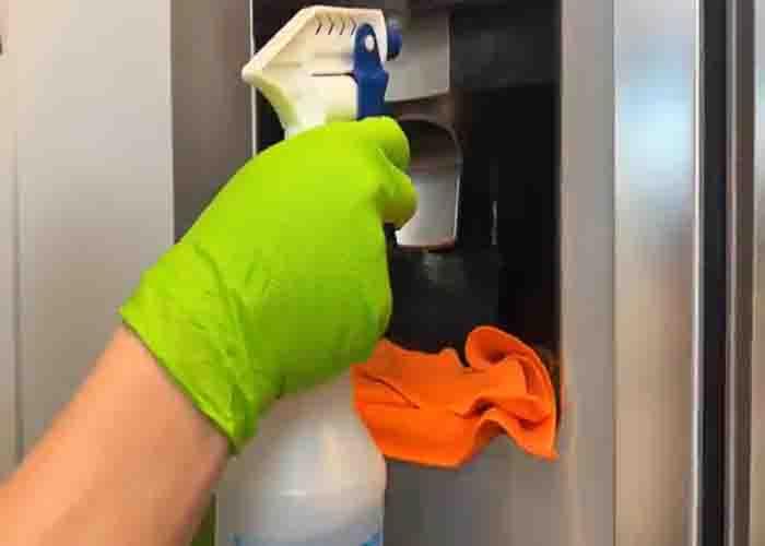 Spraying a DIY cleaning chemical to the water spigot