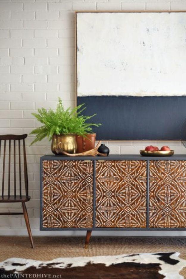 Wood sideboard with an all over stenciled geometric batik pattern across the doors under a large canvas