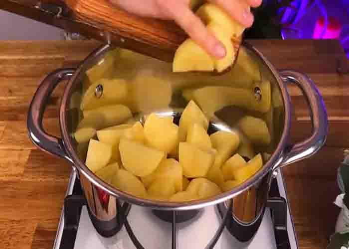 Mashing the potatoes for the canned tuna casserole