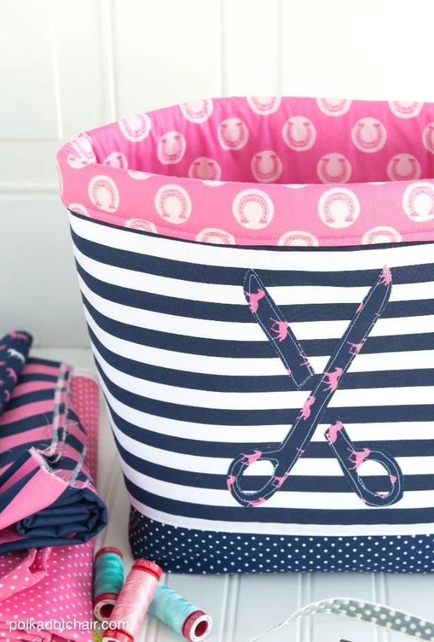 Three nested fabric storage baskets in gray and mustard cotton, standing stiff and square on a white shelf.