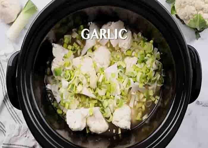 Adding the cauliflower soup ingredient to the slow cooker