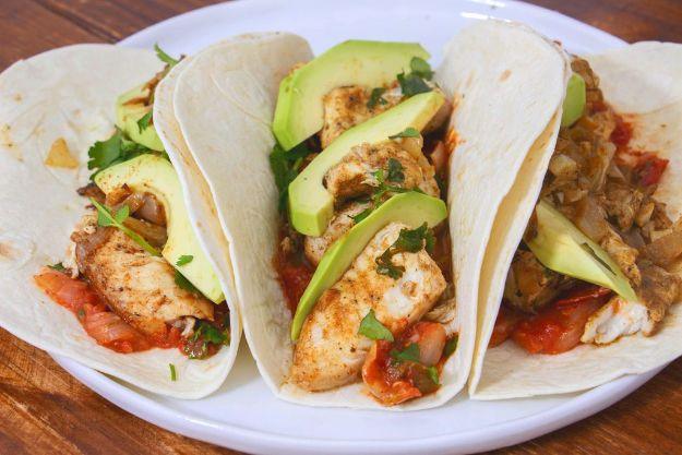 Tilapia fish tacos in warm tortillas with avocado, salsa and cilantro, an easy 20 minute fish taco recipe