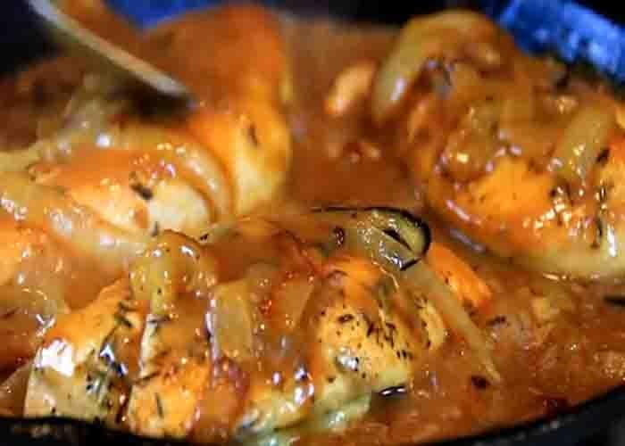 Smothering the chicken breasts with onion gravy