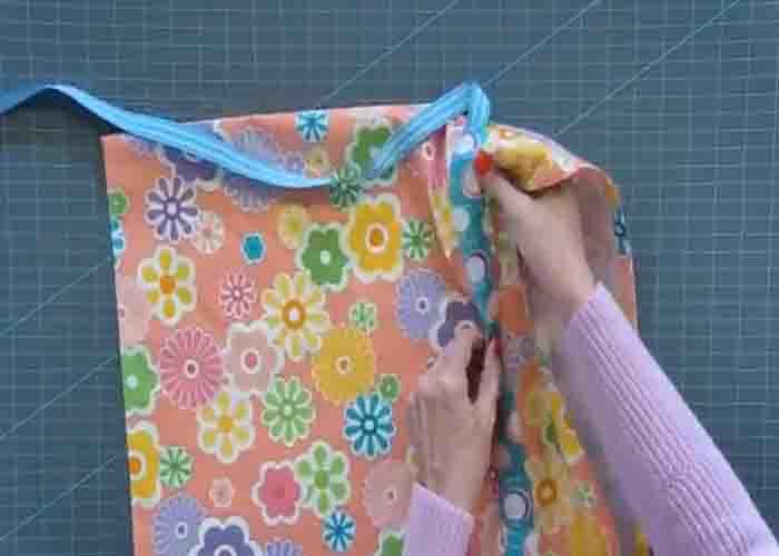 Adding the ribbon to the drawstring bag
