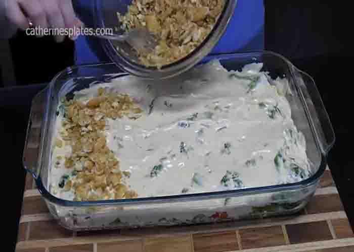 Sprinkling the crushed Ritz cracker over the chicken au gratin casserole
