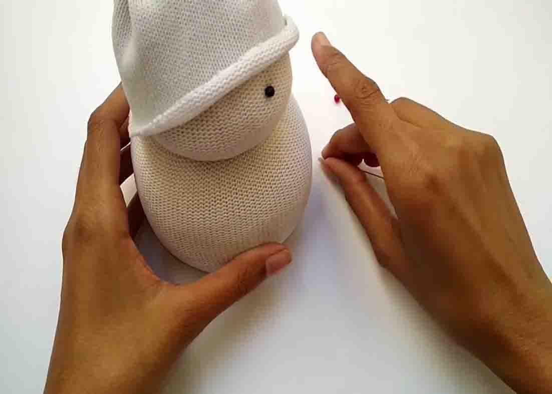 Placing the pins to make the face of the DIY snowman