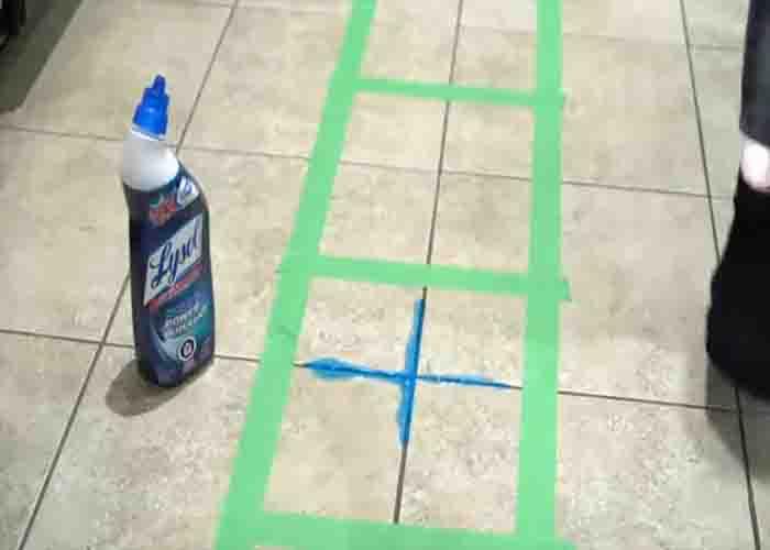 Cleaning the grout lines with toilet bowl cleaner