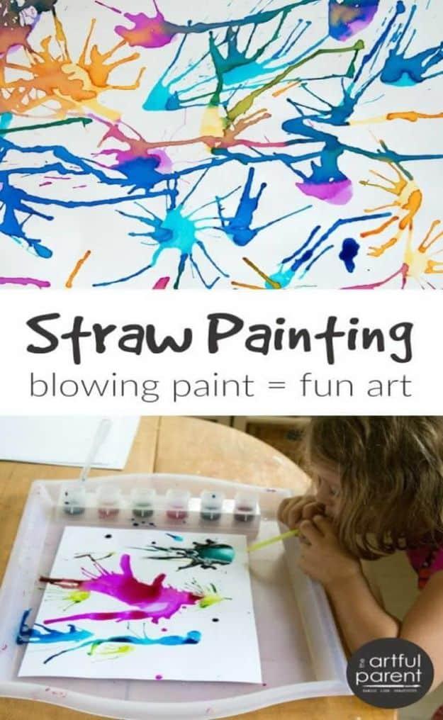 Branching blow painted splatters of blue, pink and yellow, above a photo of a child blowing paint through a straw