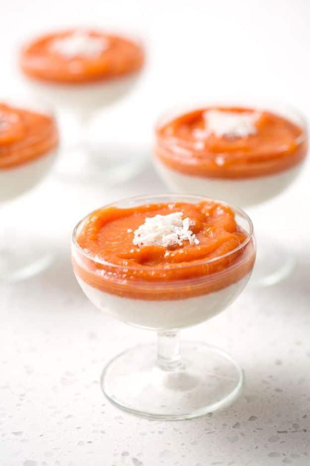 Chinese coconut pudding in stemmed glass coupes, a white coconut layer under a thick orange fruit layer