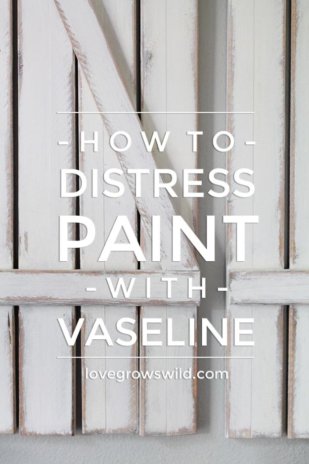 Distress paint with Vaseline, a white painted wooden shutter with worn gray edges showing through the top coat