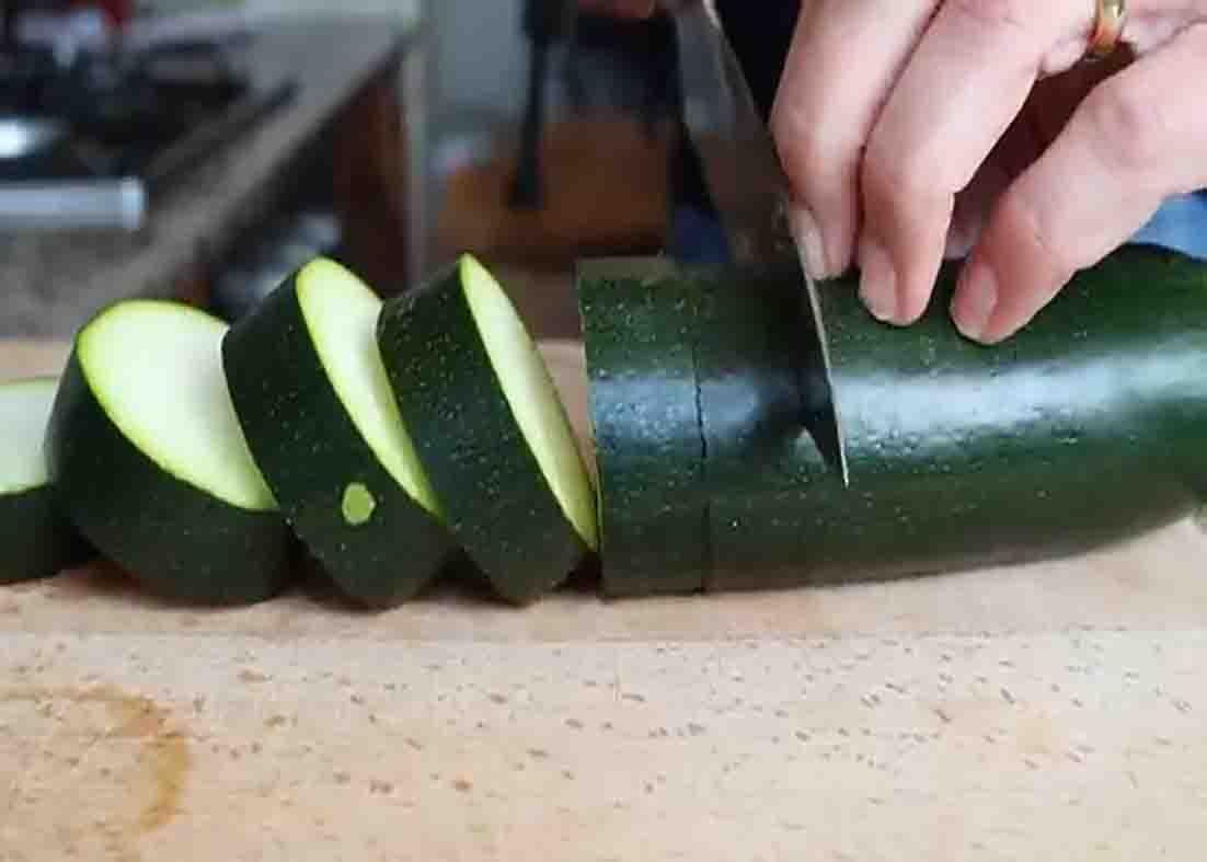 Slicing the zucchini into thick cut