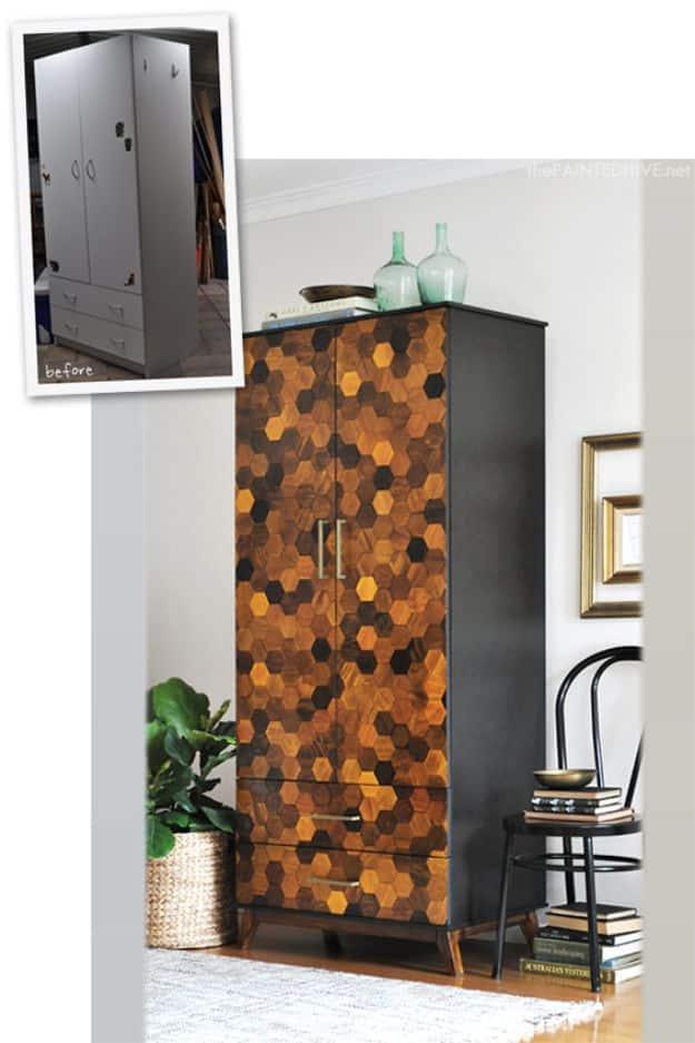 Tall black cabinet with doors covered in hand stained wooden hexagon parquetry, brass pulls, and a small before photo inset