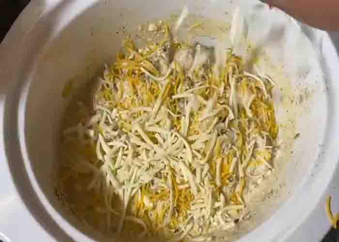 Adding the cheese over the jalapeno popper chicken