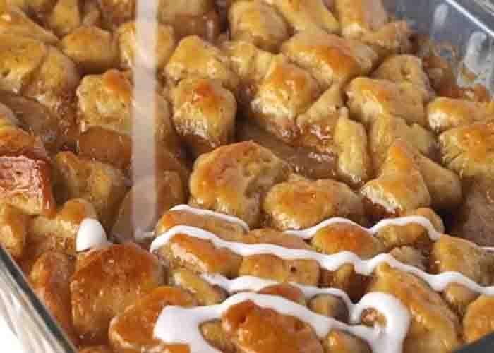 Drizzling the glaze over the apple pie bubble up