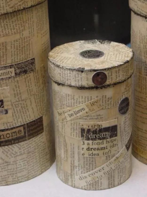 Boxes covered with old book pages using liquid starch, round canisters papered in text with a dark button lid
