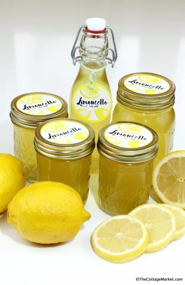 Mason jar limoncello free printable labels on jars of homemade lemon liqueur with a swing top bottle and fresh lemons