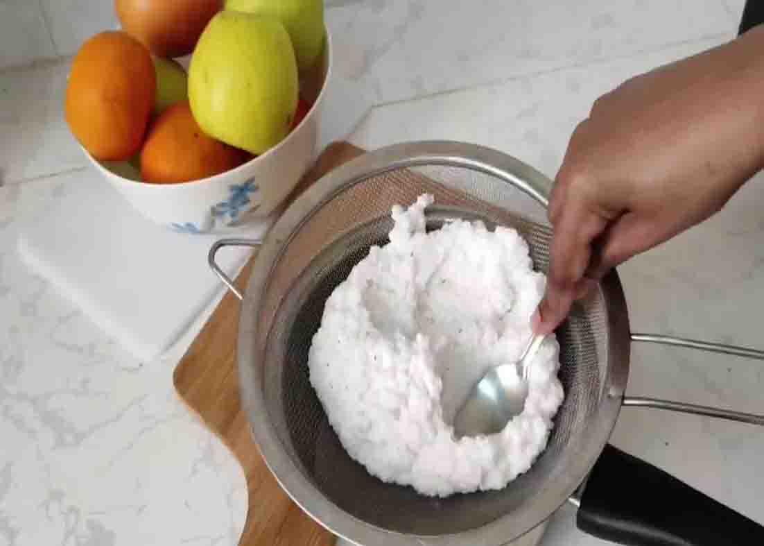 Grinding the coconut to extract the juice