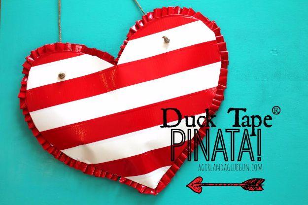 Heart shaped pinata for Valentines made from cardboard and covered in striped pink and red duct tape