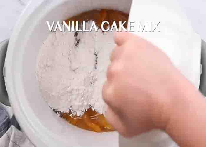 Making the peach cobbler in the crockpot