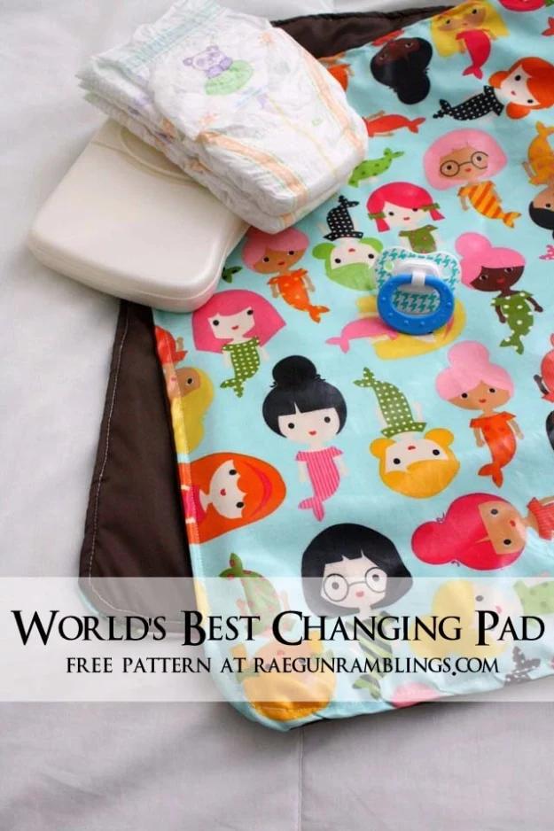 Changing pad in a bright mermaid print with a brown reverse, a stack of diapers and wipes resting on it