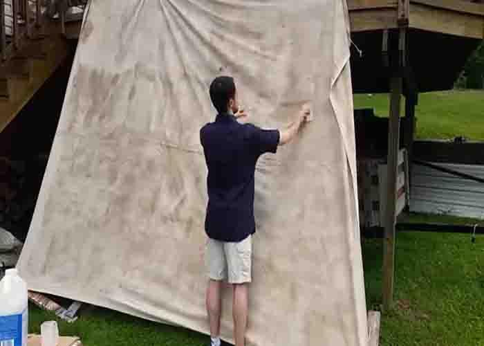 Applying the waterproofing solution to the canvas