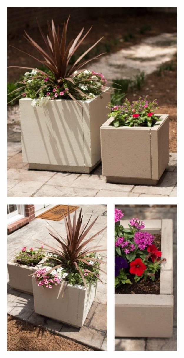 DIY curb appeal concrete planters in tan square shapes on a paver patio planted with burgundy cordyline and pink flowers