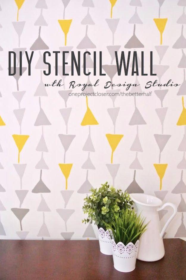 DIY stencil wall graphic showing a yellow and gray triangle pattern behind a white pitcher and plant