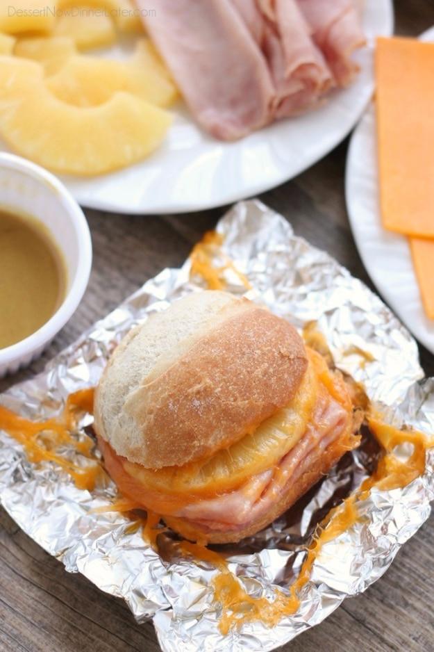 Hot ham and pineapple sandwiches wrapped in foil and warmed right over the campfire for a sweet savory meal