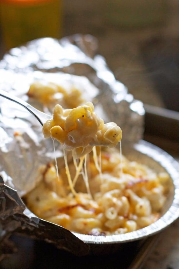 Camping recipe: mac and cheese cooked in a foil packet for a creamy comfort food dinner kids love at camp