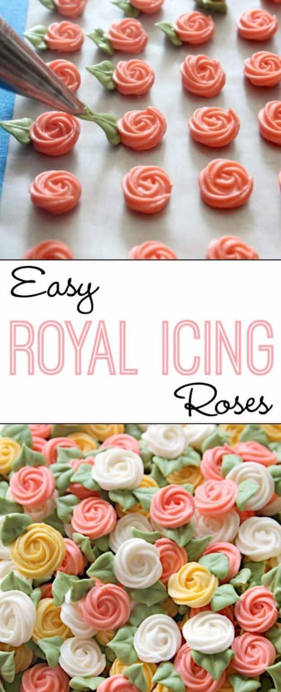 Simple swirl roses piped in stiff royal icing with a star tip onto parchment, with small green leaves