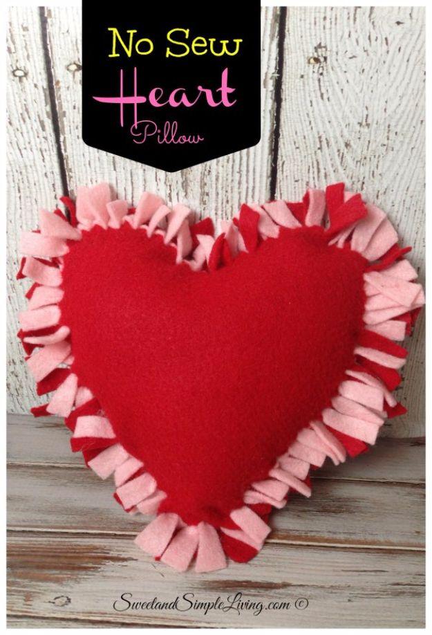 A red felt heart pillow laced together around the edges with no sewing, an easy handmade Valentine gift