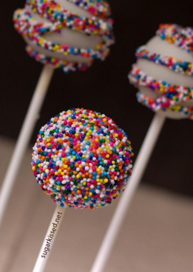 Funfetti cake pops dipped in white candy melts and rolled in rainbow nonpareils, a fun party dessert