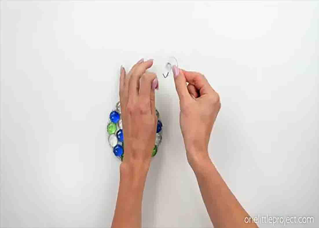 Attaching the hang of the DIY glass bead suncatcher