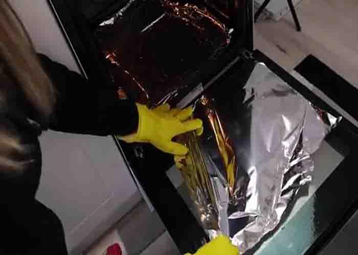 Covering the dirty area of the oven with aluminum foil