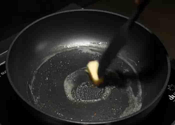 Melting the butter for grilling the peanut butter and jelly sandwich