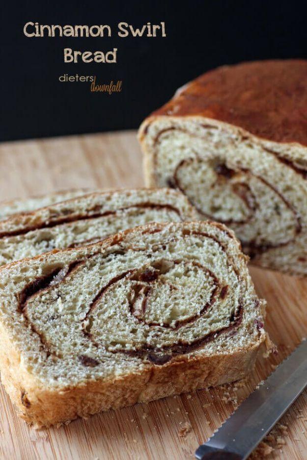 Cinnamon raisin bread sliced to show the dark cinnamon sugar swirl running through a soft raisin studded crumb