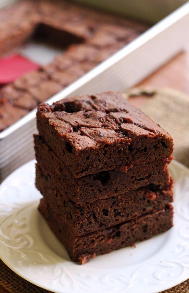 Beer brownies with salted whiskey caramel, three thick dark brownies stacked up on a small white plate