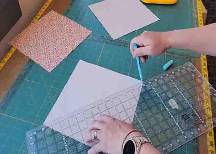 Making the half-square triangles for the baby quilt