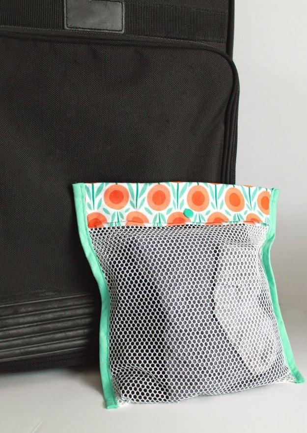 Simple mesh bag sewn with white utility mesh, an orange floral cotton top band and mint bias binding