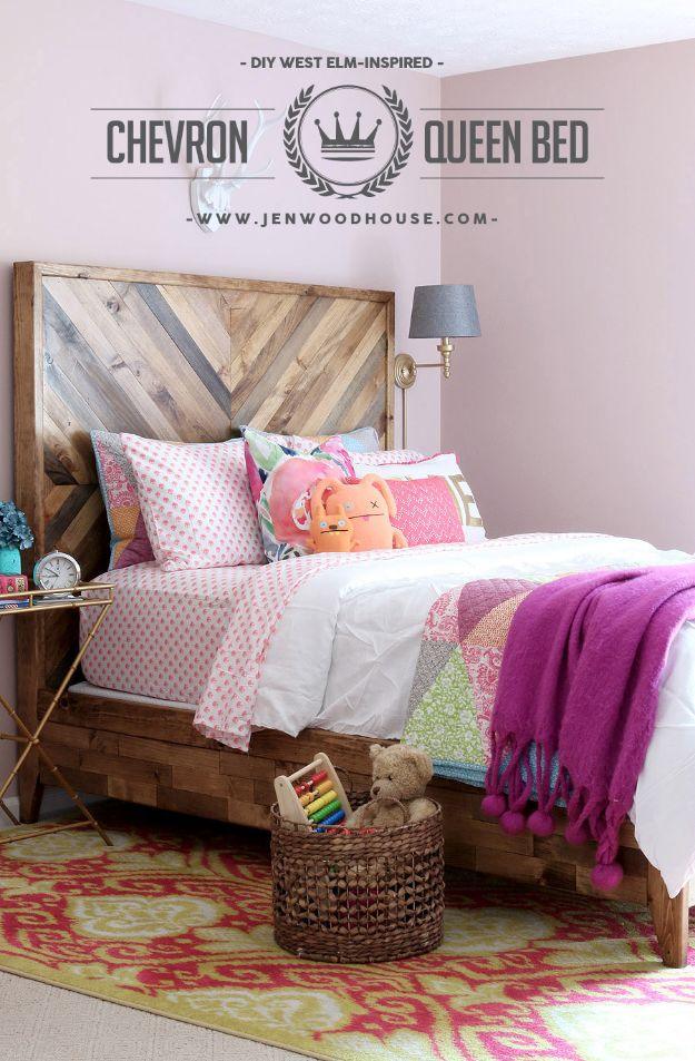 Reclaimed wood queen bed with a chevron pattern headboard in a pink girls room with colorful bedding