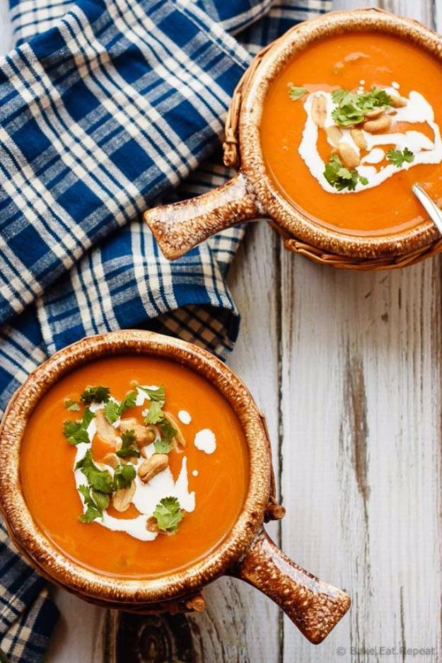 Two bowls of Thai pumpkin soup with coconut cream, cashews and cilantro for Thanksgiving recipes crockpot