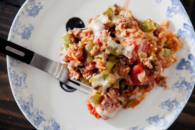Unstuffed bell pepper casserole with ground beef, green peppers, rice and melted mozzarella cheese on top