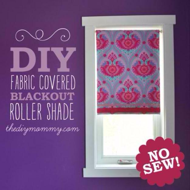 White roller blind covered in pink and purple folk floral fabric, fitted inside the casing of a white framed window
